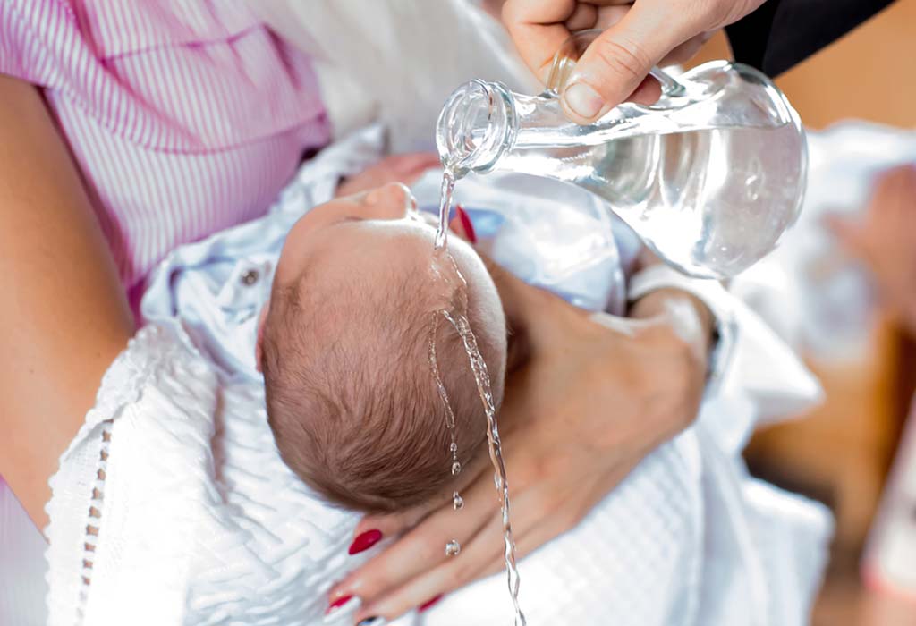 A baby being shaved by an adult.